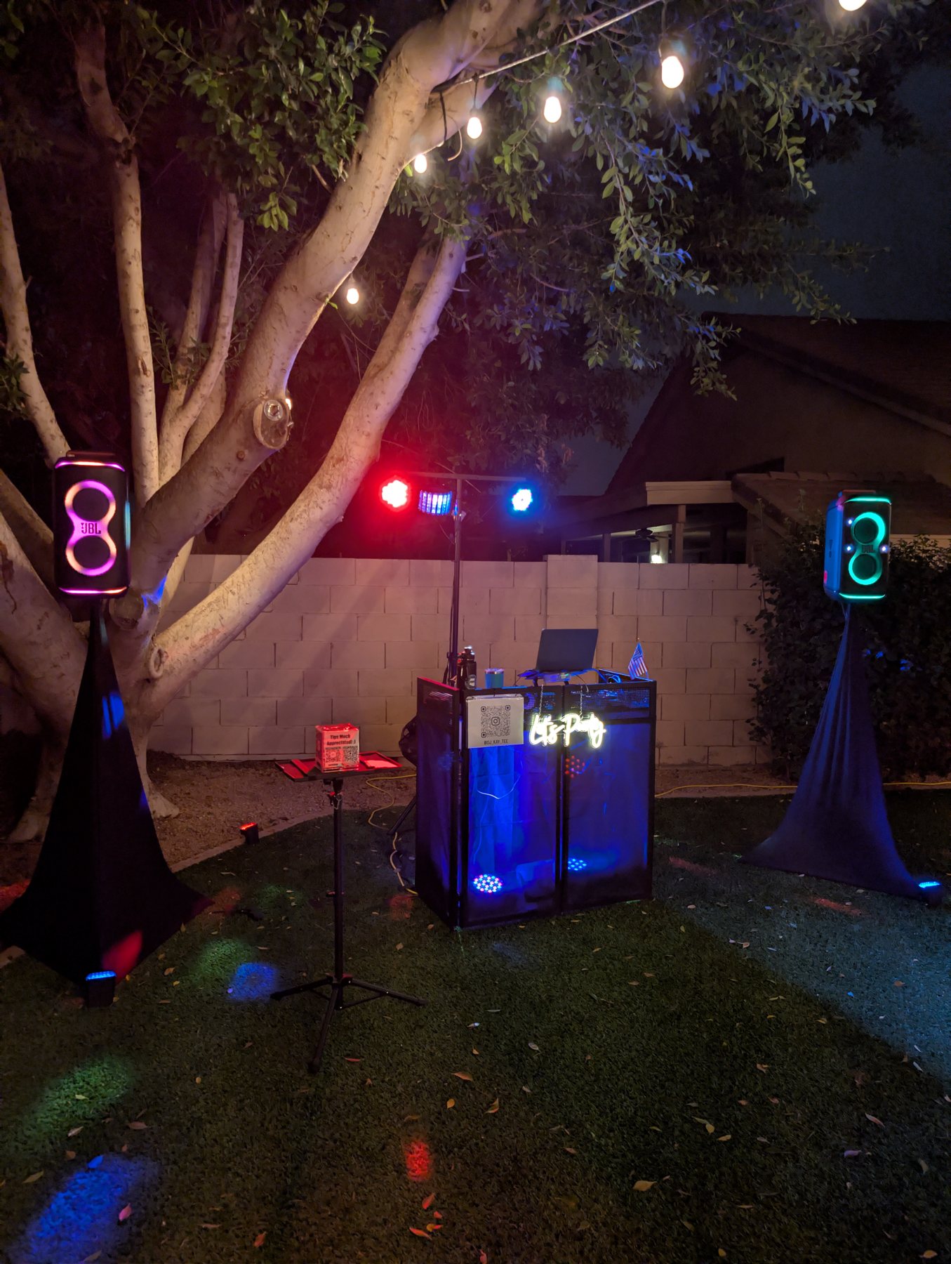 Outdoor DJ booth and colorful party lights